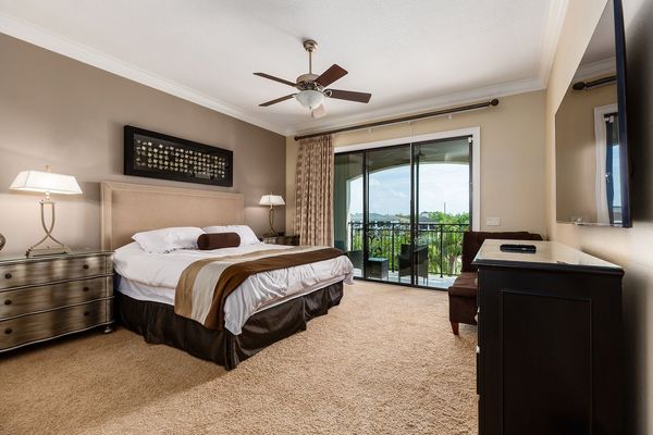 The third master suite features a king bed, 55-inch SMART TV, and access to private patio balcony