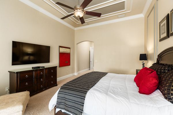This master suite is located on the ground floor with access to the pool area