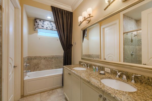 The en-suite bathroom 3 with dual vanity, bathtub, and walk-in shower