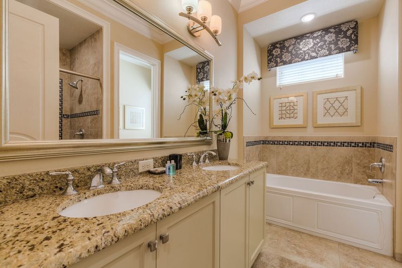 The en-suite bathroom 4 has a bathtub and glass walk-in shower
