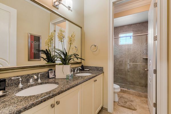 En-suite bathroom features a dual vanity and walk-in shower