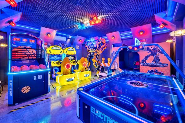 The garage games room includes a 10-foot robot replica, Bumblebee arcade game, basketball shooting game, air hockey, and a dual race car game