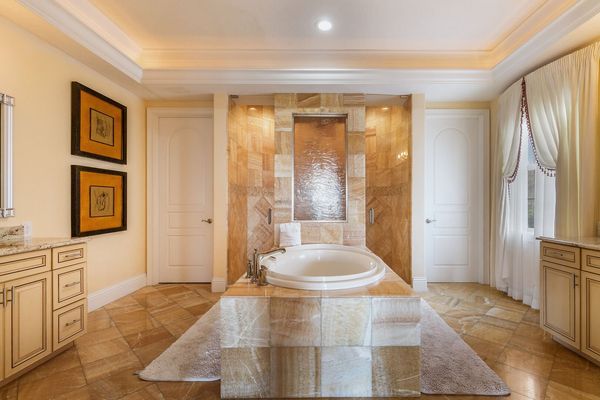 Beautiful ensuite bathroom with vanity, walk-in shower, and garden tub