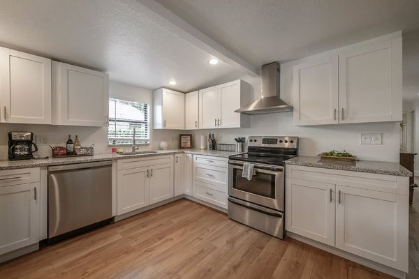 All white kitchen with stainless steel appliances