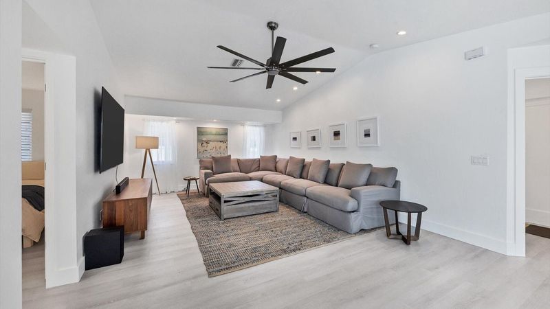Large and comfortable living room with 84" Smart TV featuring Dolby surround sound