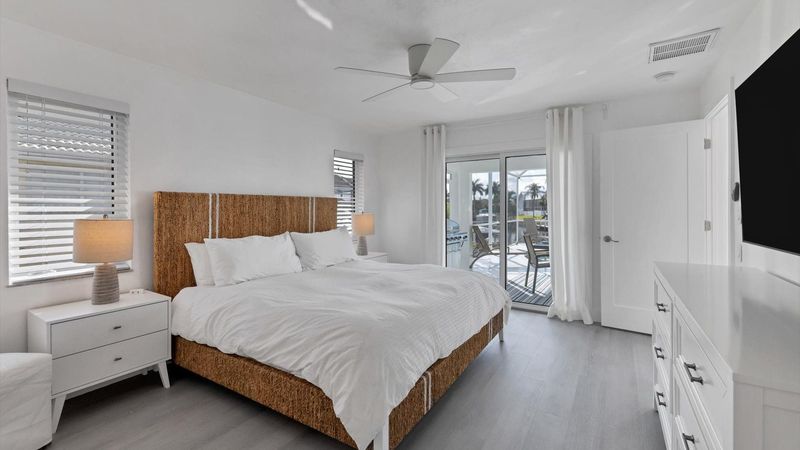 King bed in the master bedroom with lanai access
65" TV