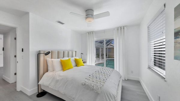 Guest bedroom with queen bed and lanai access
