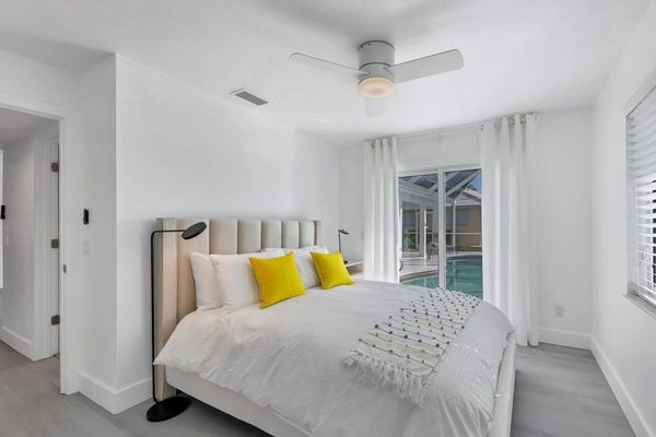 Guest bedroom with queen bed and lanai access