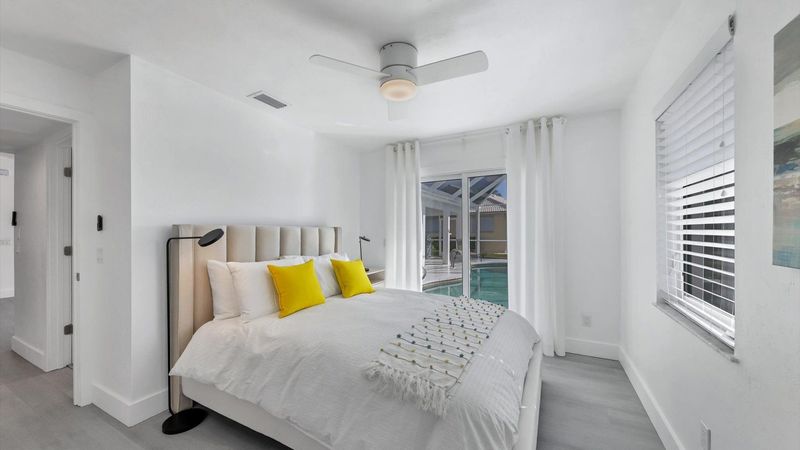 Guest bedroom with queen bed and lanai access