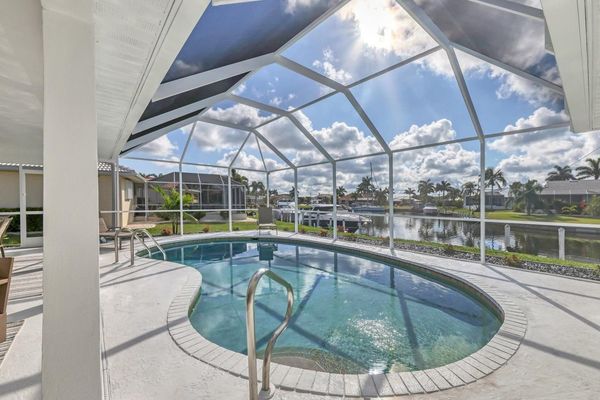 Lanai with a 27' x 15' kidney shaped pool, 7' deep overlooking the canal (Boat lift not available)