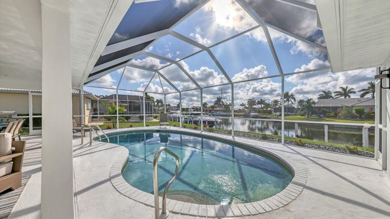 Lanai with a 27' x 15' kidney shaped pool, 7' deep overlooking the canal (Boat lift not available)