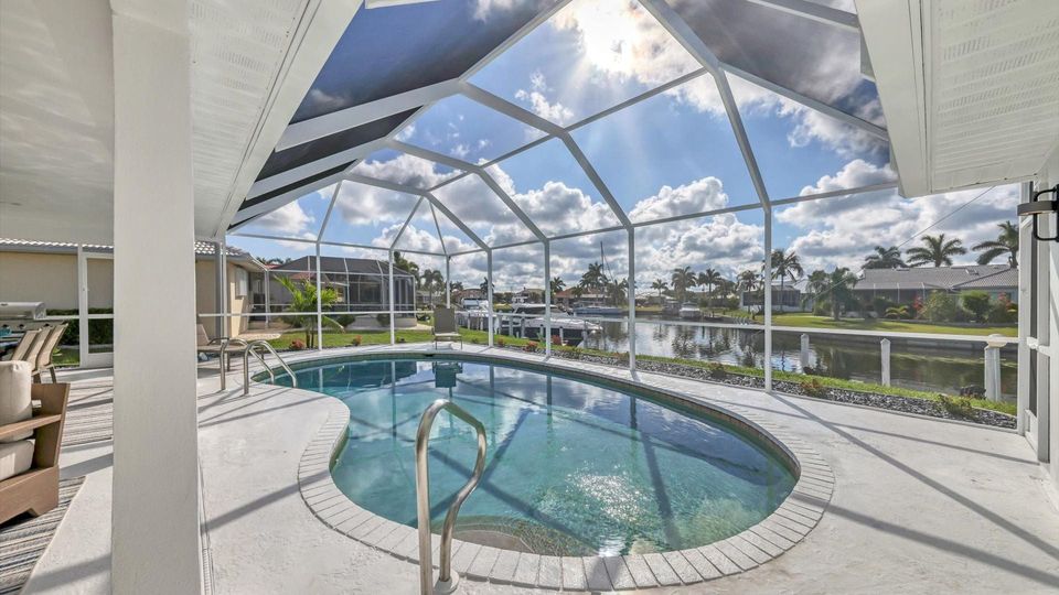 Lanai with a 27' x 15' kidney shaped pool, 7' deep overlooking the canal (Boat lift not available)