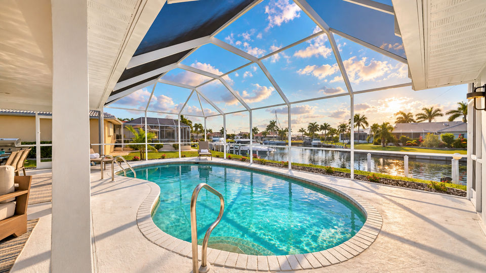 Sparkling 27' x 15' kidney shaped pool, 7' deep overlooking the canal (Boat lift not available)