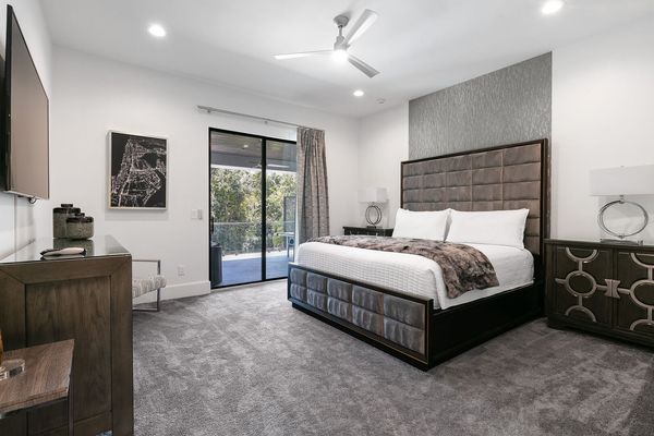 Master Suite bedroom furnished with a king-size bed, with balcony access