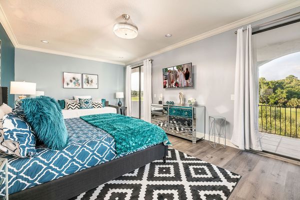 This second-floor master suite with a king-sized bed offers a private balcony with golf course views