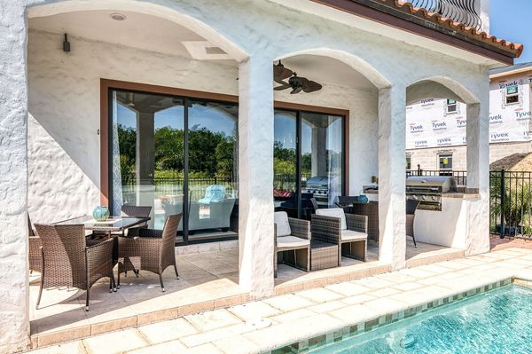Cook outside in the summer kitchen with BBQ grill and dine al fresco at one of the 2 patio tables, each seating 4