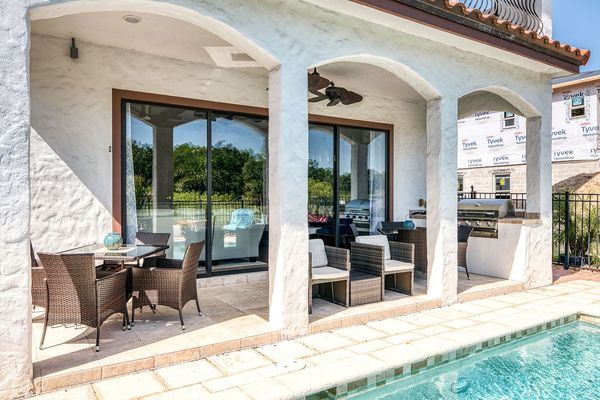 Cook outside in the summer kitchen with BBQ grill and dine al fresco at one of the 2 patio tables, each seating 4