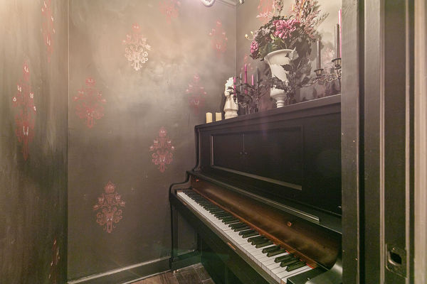 The self-playing piano gives the eery feel of a haunted house!