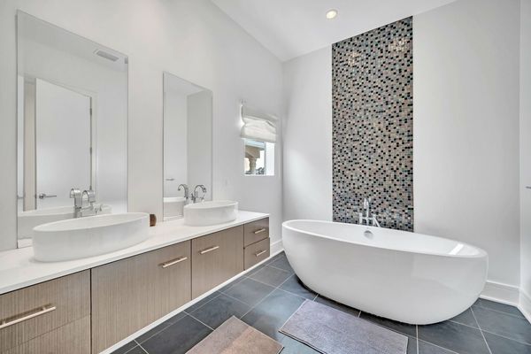 The large en suite bathroom features a soaking tub and walk in shower
