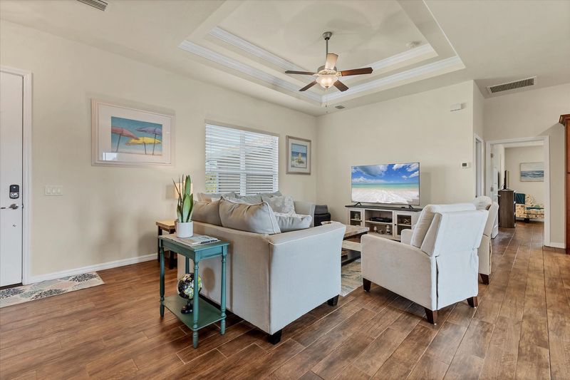 Open, comfortable living room with 65-inch Smart TV