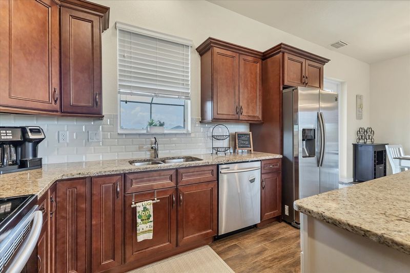 Fully-equipped kitchen overlooking the living & dining areas. Kitchen island seats 3