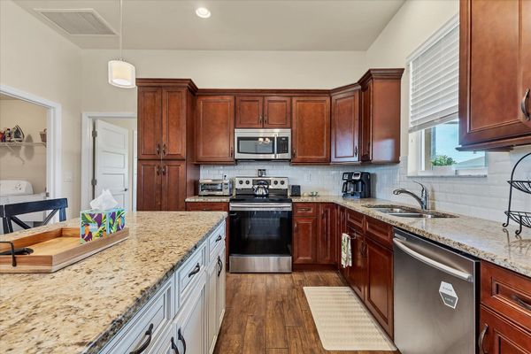 Fully-equipped kitchen overlooking the living & dining areas. Kitchen island seats 3