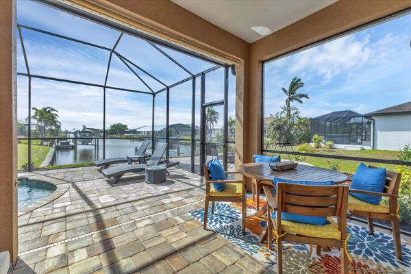 Beautiful outdoor living space over looking the sparkling pool and canal