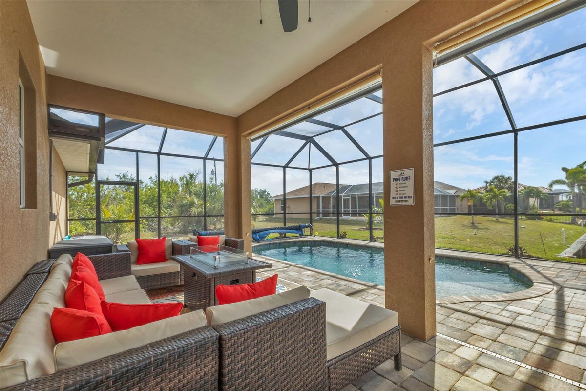 Beautiful outdoor living space over looking the sparkling pool and canal