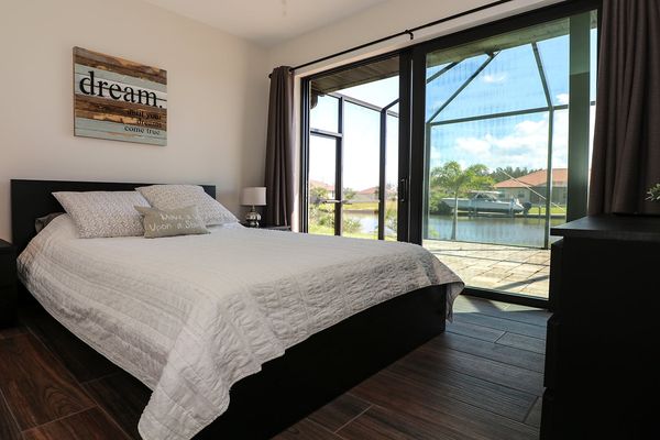 Queen guest bedroom with patio access