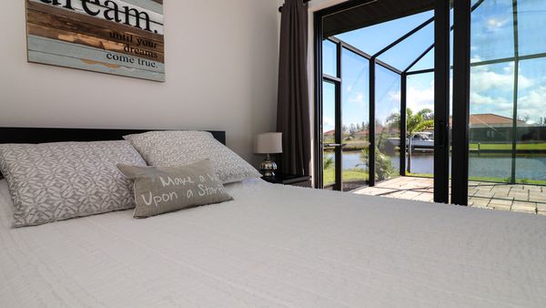 Queen guest bedroom with patio access. 42" Smart TV & DVD player.