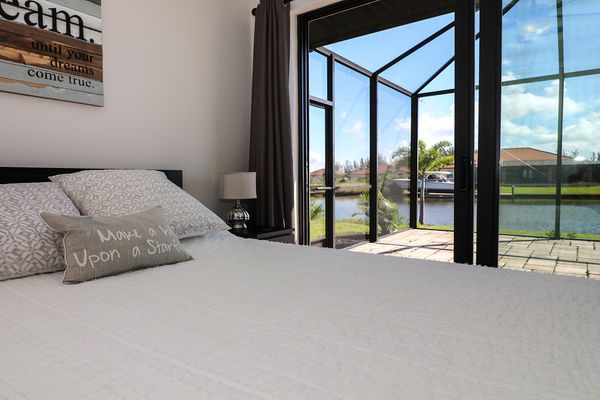 Queen guest bedroom with patio access. 42" Smart TV & DVD player.