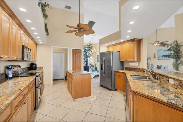 Large, open, fully-equipped kitchen overlooking breakfast table & living room