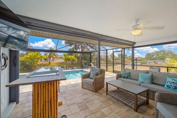 Great outdoor living space over the sparkling pool and canal.