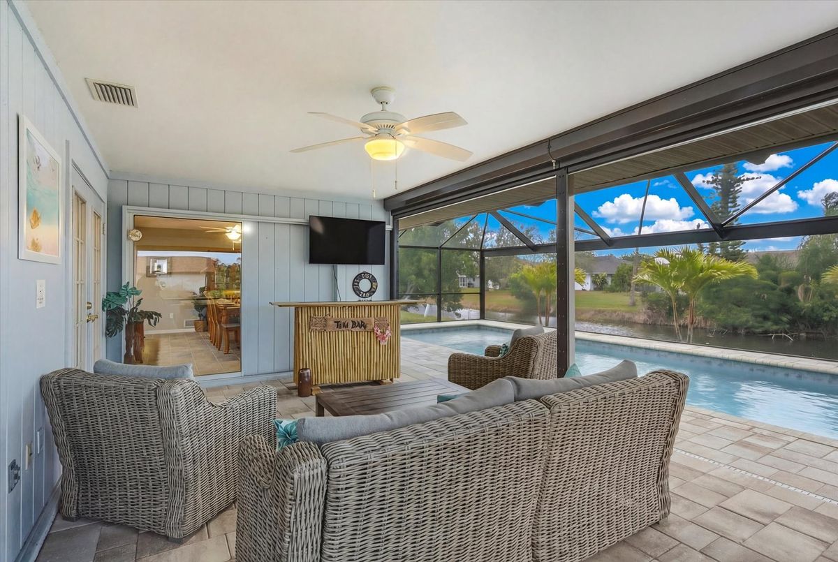 Outdoor living space overlooking the sparkling private pool