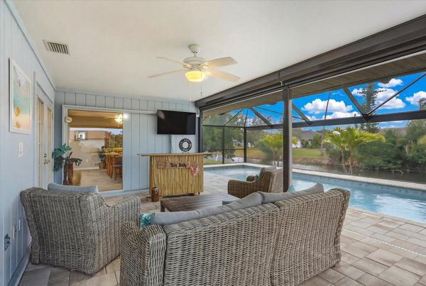 Outdoor living space overlooking the sparkling private pool
