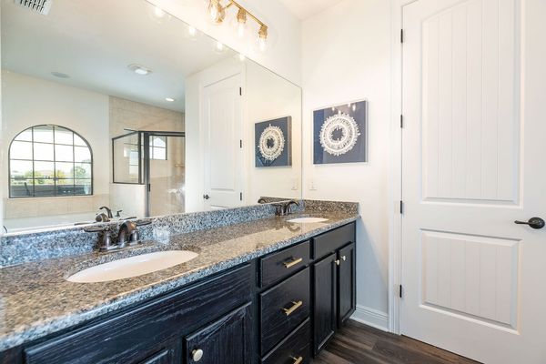 The en suite bathroom includes a spacious double vanity