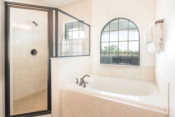 The master suite bathroom features a garden tub and separate walk-in shower