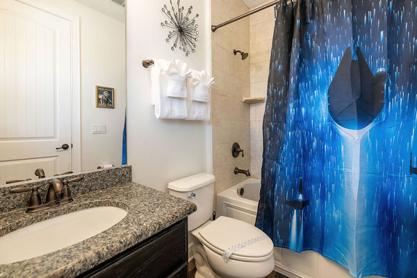 The en suite bathroom offers a combined tub and shower