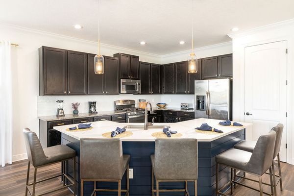 The fully equipped kitchen, complete with granite countertops and stainless-steel appliances, makes preparing meals a delight