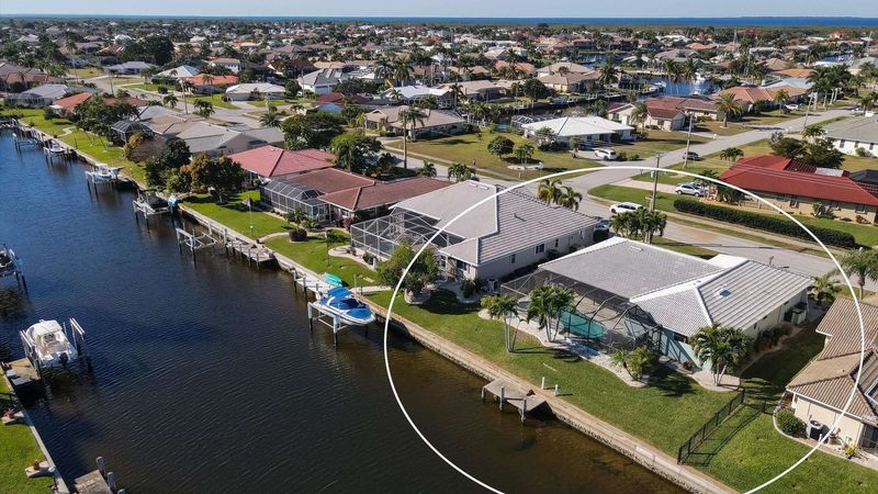 Aerial view of the house on canal and Charlotte Harbor just beyond (Boat lift not available)