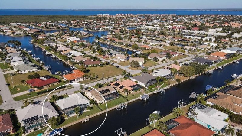 Aerial view of the house on canal and Charlotte Harbor just beyond (Boat lift not available)