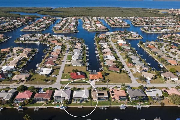 Aerial view of the house in the Punta Gorda Isles canal network and Charlotte Harbor just beyond (Boat lift not available)