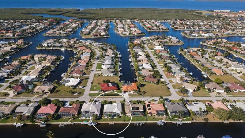 Aerial view of the house in the Punta Gorda Isles canal network and Charlotte Harbor just beyond (Boat lift not available)