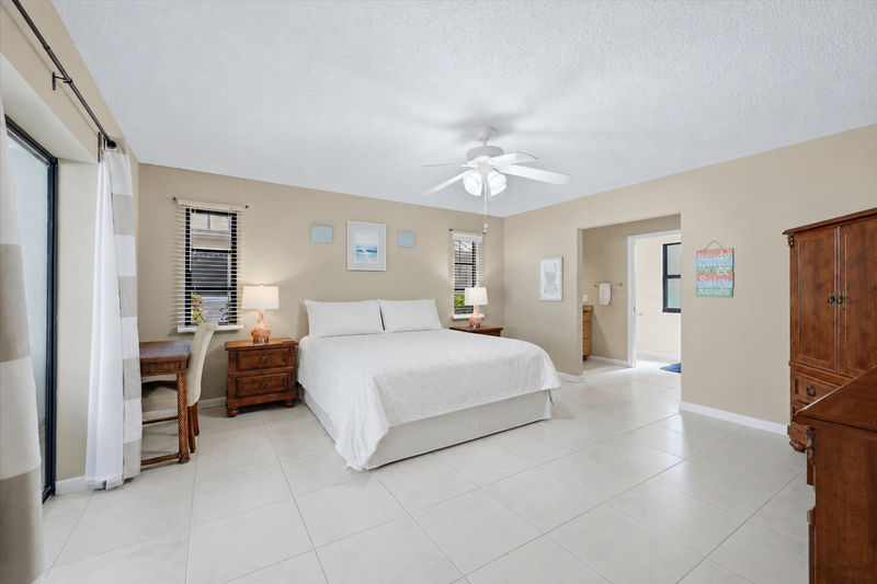 Primary bedroom with attached bathroom and lanai access
