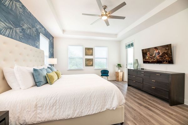 This second-floor master suite has a private balcony overlooking the pool and golf course