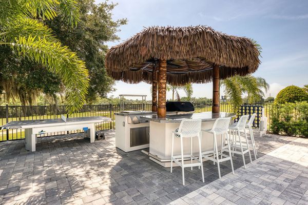 Enjoy a friendly game of ping pong under the shade of the palm tree