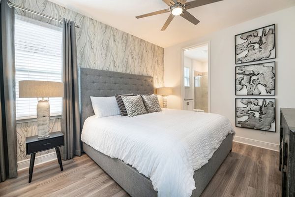 This bedroom features a plush king-sized bed and an en suite bathroom