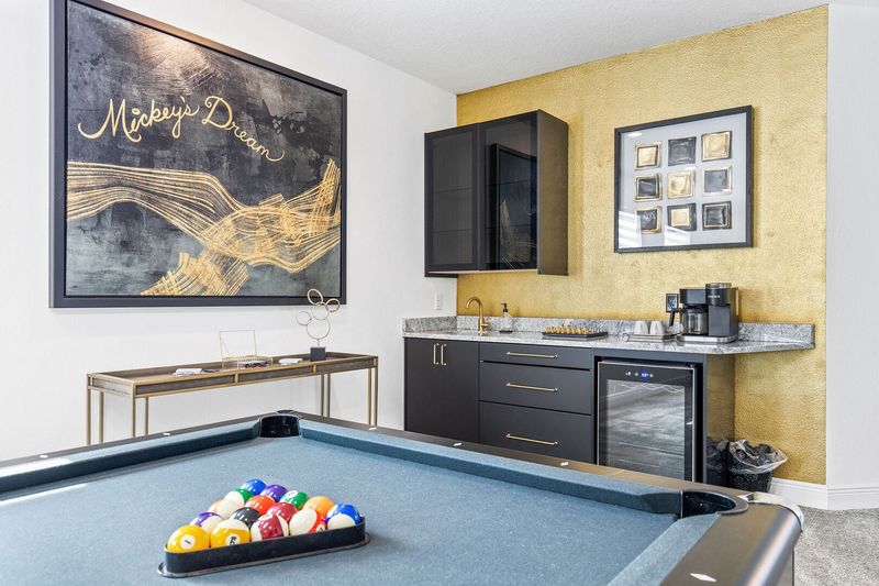 The morning kitchen completes the space with a sink, fridge, and coffee maker.