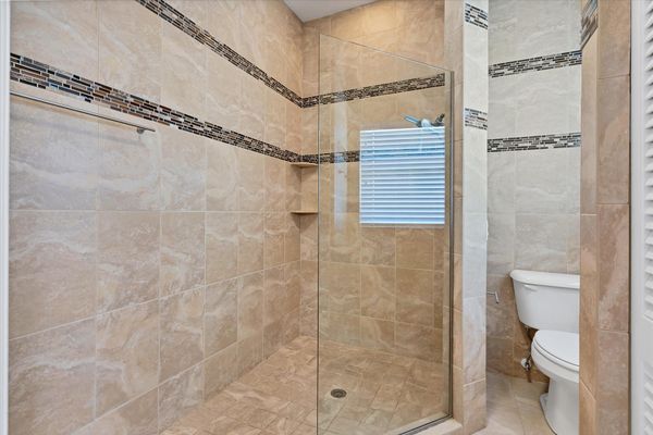 En suite features a large walk-in shower and double vanities