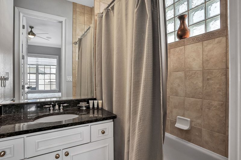 This en suite bathroom has a combined tub and shower